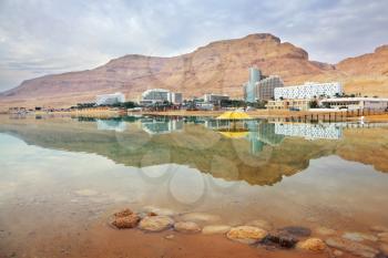 Winter in the Dead Sea. The comfortable high-rise hotels are reflected in the sea smooth water