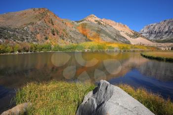 North Lake and White Rock. Mountains covered with orange and yellow bushes are reflected in the blue water lakes