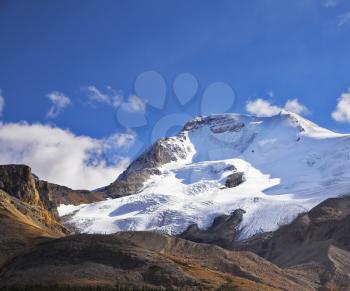 Majestic mountain landscape, glaciers and the snow slopes shined by the sun