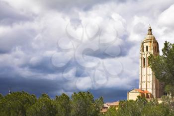 Tower of a cathedral in Segovia on a background of the cloudy sky