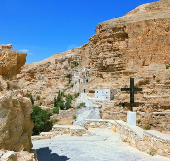 The guiding signpost - Black Cross. The famous monastery of St. George Cozeba. The building of the monastery was built on the wall of the gorge of Wadi Kelt near Jerusalem. 