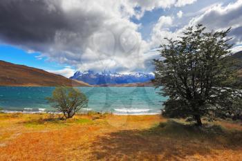  Thundercloud closes the sky. The gale on the Emerald Lake. In the distance the mountains with snow-capped