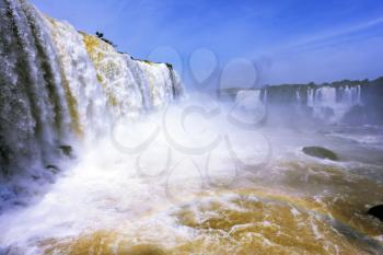  White whipped foam of water and a thin mist over the water. The most high-water waterfall in the world - Iguazu