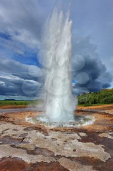 Magnificent geyser Strokkur. Summer in Iceland. Fountain Geyser throws hot water every few minutes