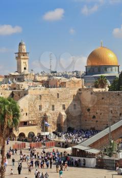 JERUSALEM, ISRAEL - SEPTEMBER 20, 2013: Sunny morning in the holiday of Sukkot. Morning prayer at the Western Wall of the Temple. Religious Jews in white prayer shawls