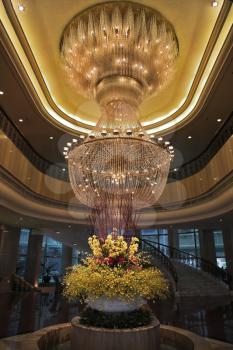 Magnificent huge luster and vase with flowers in a lobby of prestigious hotel in China