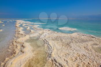 Israel in October. The picturesque path from the evaporated salt in the Dead Sea. Salt formed long paths with scalloped edges 