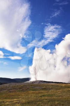 The most well-known of the world geyser in Yellowstone national park - Old Faithful. The beginning of eruption