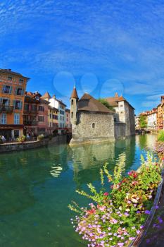 Charming old town of Annecy in Provence. Bastion- prison turned into  museum, is reflected in the water channel. Clear early morning