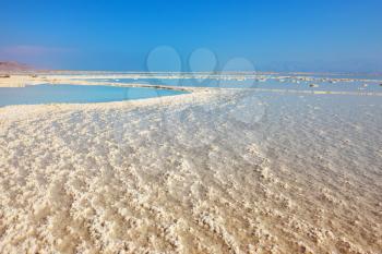 The shoaled Dead Sea at coast of Israel. The condensed salt out over a water surface 