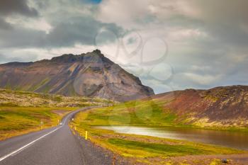 Cloud Iceland in the summer. The highway passes among the mountains and lakes