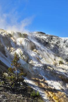 Spring wind above a smoking volcanic hill in Yellowstone national Park