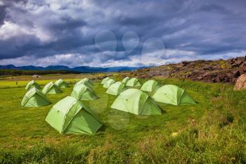 Summer holidays in Iceland. Scenic camp on a green meadow
