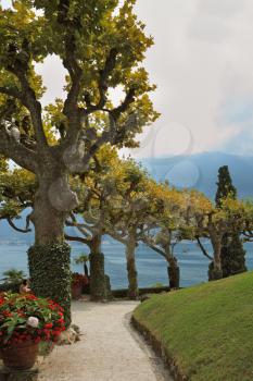 Magnificent park at the Italian villa-museum Balbyanello. Lake Como in the misty haze
