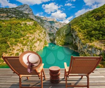 Travel across Provence. Two wooden chaise lounges on platform at the lake Verdon