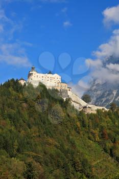Majestic medieval Burg Hohenwerfen. The castle is situated on top of the mountain and surrounded by dense forest