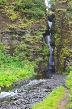 Magnificent waterfall inside a cave near Selyalandfoss. Iceland, July
