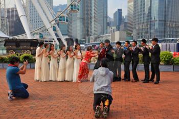 HONG KONG, DECEMBER 11, 2014: Hong Kong Special Administrative Region. The modern city on the ocean coast. Youth wedding photographed in a public park near the ferris wheel