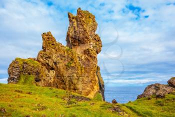 Magnificent Iceland. The picturesque rocks covered with a green and yellow moss. Northern coast of Atlantic