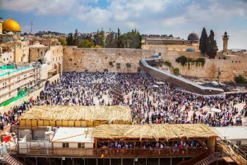 The huge crowd of Jews for a prayer has gathered on the square. Western Wall of the Temple. Autumn holiday of Sukkot in Jerusalem. 