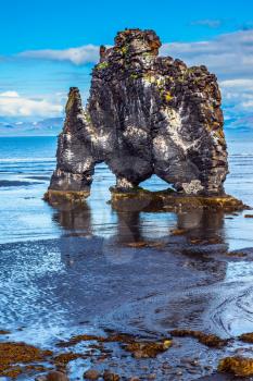 Hvitserkur - basalt rock in the form of a huge scary monster. Northwest Iceland. The concept of extreme northern tourism