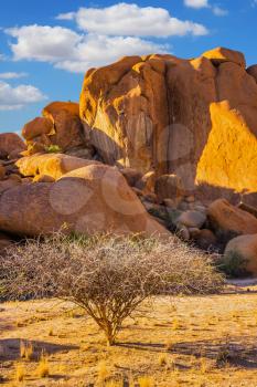  Concept of extreme and ecological tourism. The granite outcrops in the Desert Namib. Stone of Spitzkoppe, Namibia. Play of light and shadow on the rocks