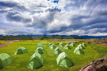 Scenic camp on a green meadow. Summer holidays in Iceland
