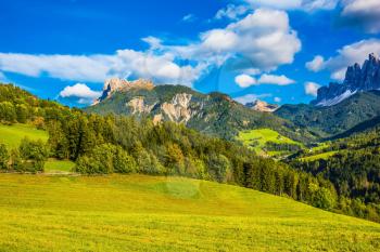Warm autumn day. Rural pastoral in the Val de Funes, Dolomites. The slope of the mountain. The concept of ecological tourism