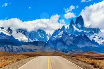 Fine highway to the grandiose Mount Fitz Roy. Argentine Patagonia. The concept of active and extreme tourism. Summer sun and blue sky above the prairie