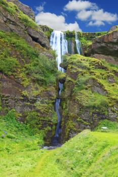 Iceland, July. Abounding scenic waterfall inside a cave near Selyalandfoss