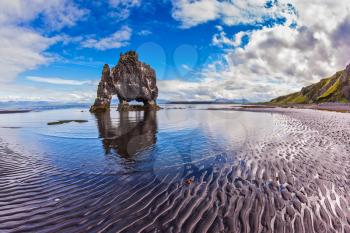 Stone mammoth Iceland. The picturesque cliff in Bay of Hoonah during low tide at sunset