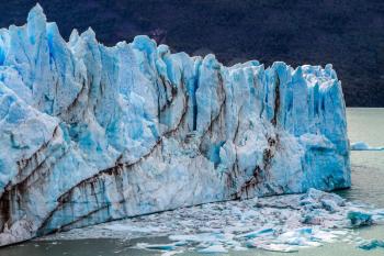 Patagonian province of Santa Cruz, Lake Argentino. On the surface of the glacier, the Kalgaspors - penitent firn. In the water floats ice crumbs. The concept of exotic and extreme tourism