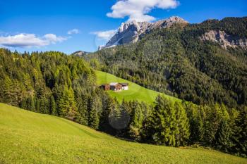 Dolomites, Val de Funes valley. Lovely day. Picturesque mountains surround the green alpine meadows of the valley