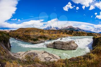  Patagonia, Torres del Paine National Park - Biosphere Reserve. Chile, Cascades Paine. Cold emerald water of the river Paine with a roar there pass rocky barriers