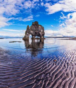 Stone mammoth Iceland. The picturesque cliff in Bay of Hoonah during low tide at sunset