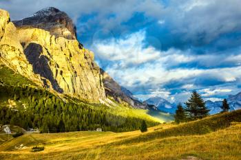 Last sunny day of fall. To pass Faltsarego approaching snowstorm. Travel in the Dolomites. Concept of active and extreme tourism