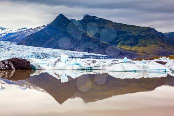 The concept of northern extreme tourism. The largest glacier in Iceland - Vatnajokull  in the summer sunset. Glacier provides water Jokulsarlon Ice Lagoon 