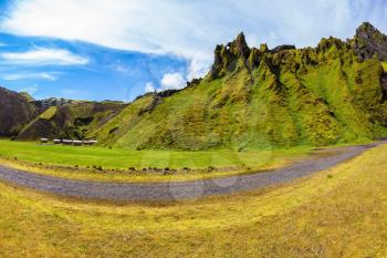 The photo was taken Fisheye lens. Camping in the canyon Pakgil, Iceland. The canyon -  green grass and moss on fantastic rocks. On canyon there is dirt road
