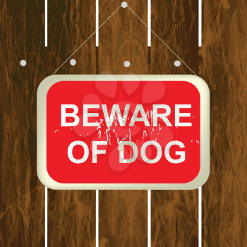 Beware of a dog sign on a wooden fence