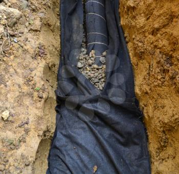 Water drainage system on a construction site with drainage tube and geotextile