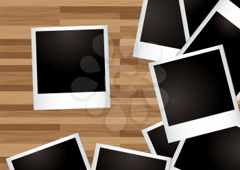 Royalty Free Clipart Image of a Stack of Polaroids on Wood