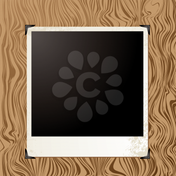 Royalty Free Clipart Image of a Polaroid on Wood