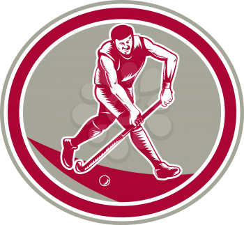 Illustration of a field hockey player running with stick striking ball set inside oval shape done in retro woodcut style on isolated background.