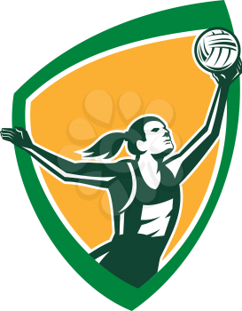 Illustration of a netball player catching rebounding ball set viewed from the side set inside shield crest on isolated background done in retro style. 