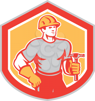 Illustration of a builder construction carpenter worker holding hammer set inside shield on isolated background done in retro style.