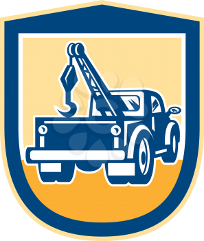 Illustration of a tow wrecker truck lorry viewed from rear set inside shield crest done in retro style on isolated background.