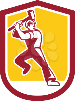Illustration of a union worker striking using sledgehammer hammer done in retro style set inside shield crest on isolated white background.