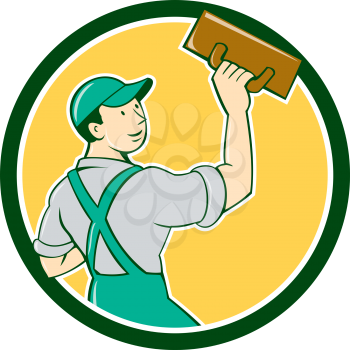 Illustration of a plasterer masonry tradesman construction worker standing with trowel looking to the side viewed from rear set inside circle on isolated background done in cartoon style. 