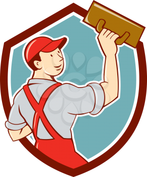 Illustration of a plasterer masonry tradesman construction worker standing with trowel looking to the side viewed from rear set inside shield crest on isolated background done in cartoon style. 