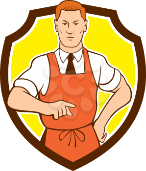 Illustration of a cook chef with hand on hips pointing facing front set inside shield crest on isolated background done in cartoon style. 
